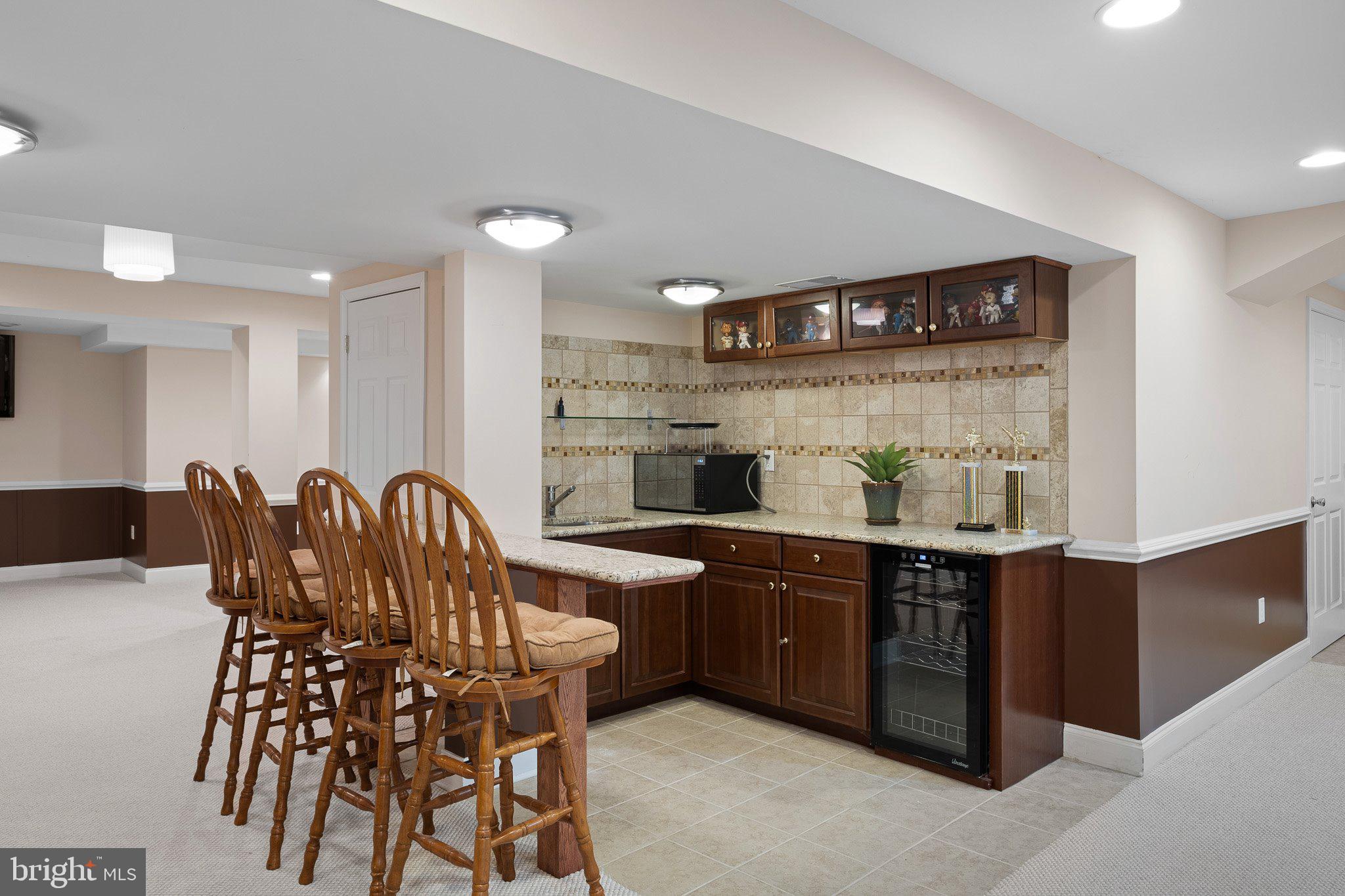 407 Nattull Drive Bear, DE 19701 - Photo 42 of 65 a kitchen with stainless steel appliances granite countertop a table and chairs in it