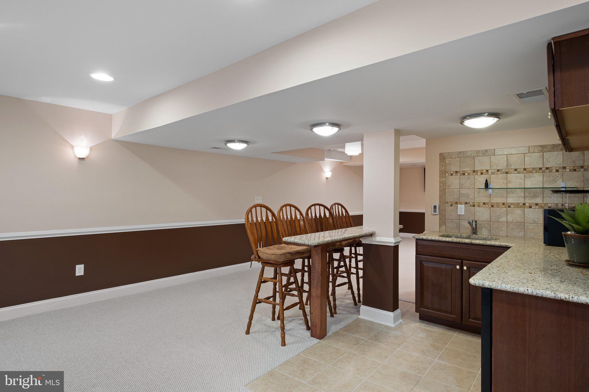 407 Nattull Drive Bear, DE 19701 - Photo 43 of 65 a kitchen with stainless steel appliances kitchen island granite countertop a sink and a refrigerator