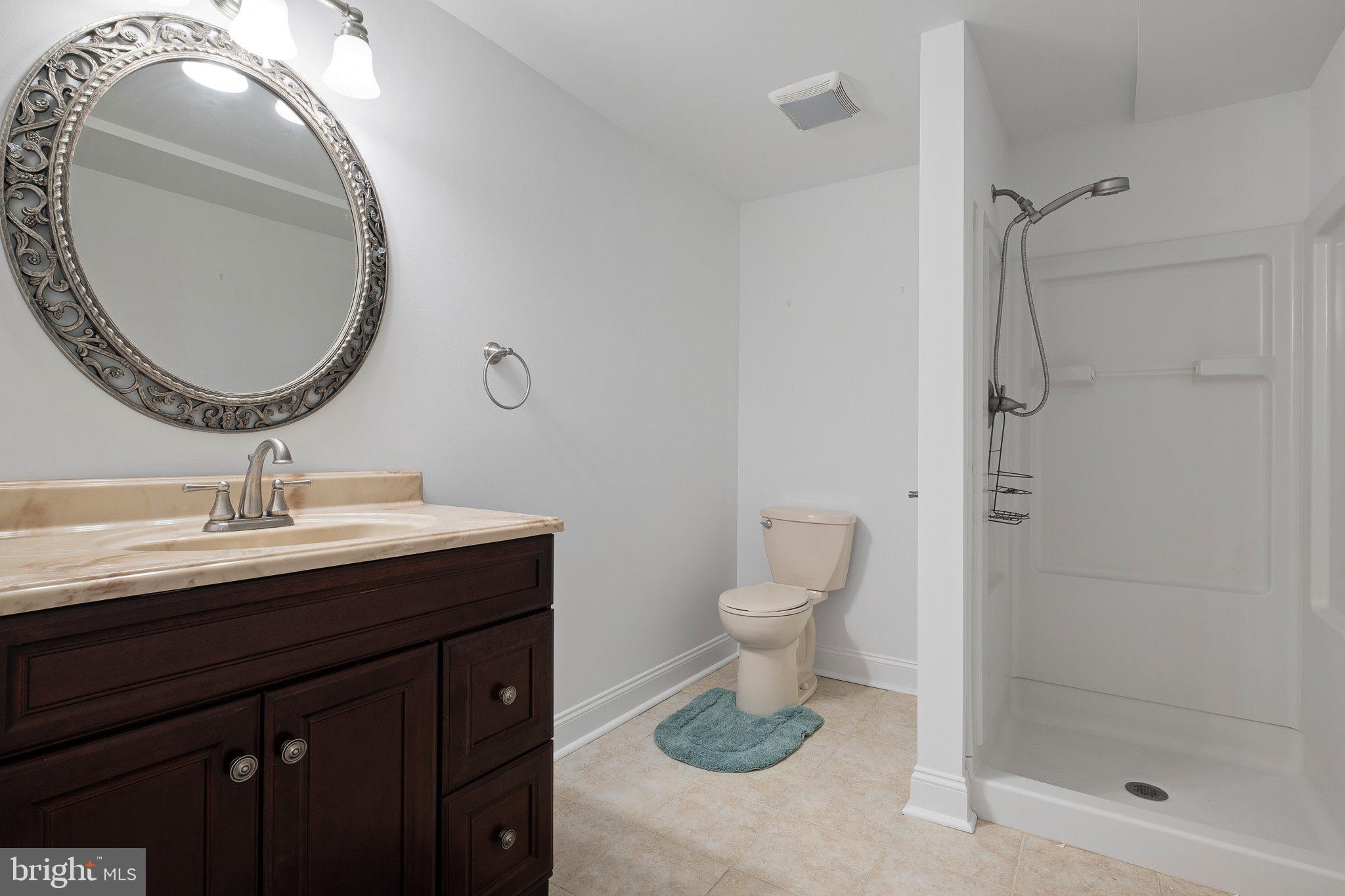 407 Nattull Drive Bear, DE 19701 - Photo 46 of 65 a bathroom with a sink a toilet and shower