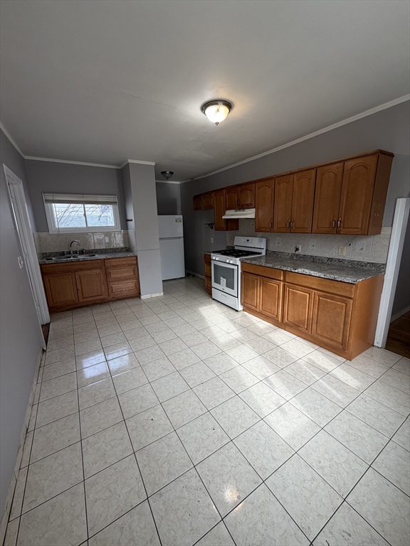 43 Adams Street, Unit 1 Lynn, MA 01902 - Photo 1 of 10 a kitchen with stainless steel appliances cabinets a sink and a stove