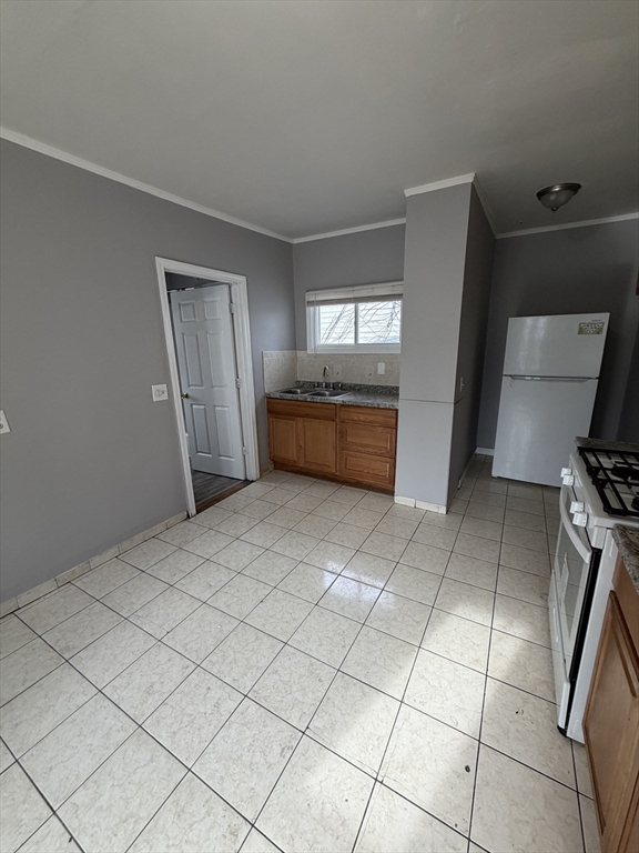 43 Adams Street, Unit 1 Lynn, MA 01902 - Photo 3 of 10 a large white room with a washer and dryer
