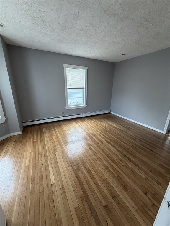 43 Adams Street, Unit 1 Lynn, MA 01902 - Photo 5 of 10 a view of an empty room and wooden floor and a window