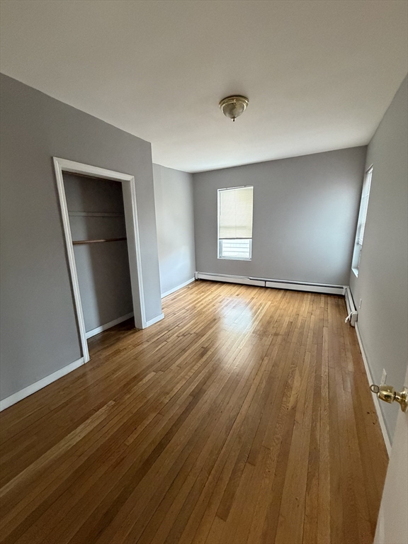 43 Adams Street, Unit 1 Lynn, MA 01902 - Photo 8 of 10 a view of empty room with wooden floor and fan