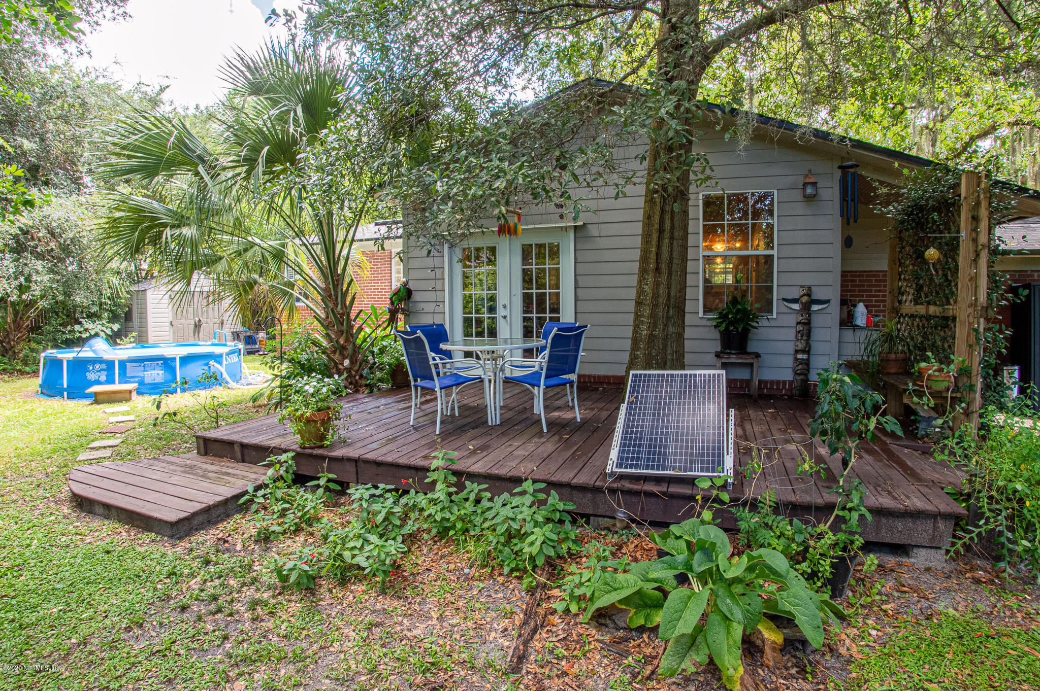 5418 Stetson Road Jacksonville, FL 32207 - Photo 29 of 34 a view of a patio with table and chairs potted plants and large tree