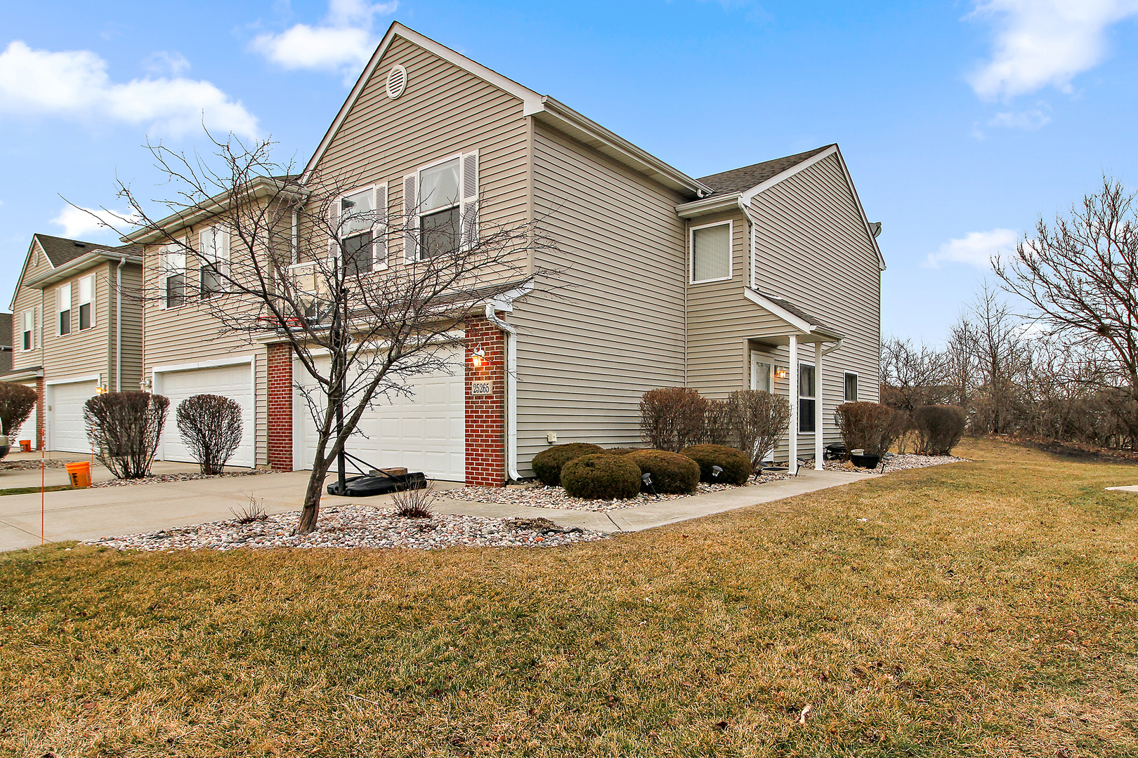 25265 Faraday Road, Unit 25265 Manhattan, IL 60442 - Photo 1 of 15 a front view of a house with a yard