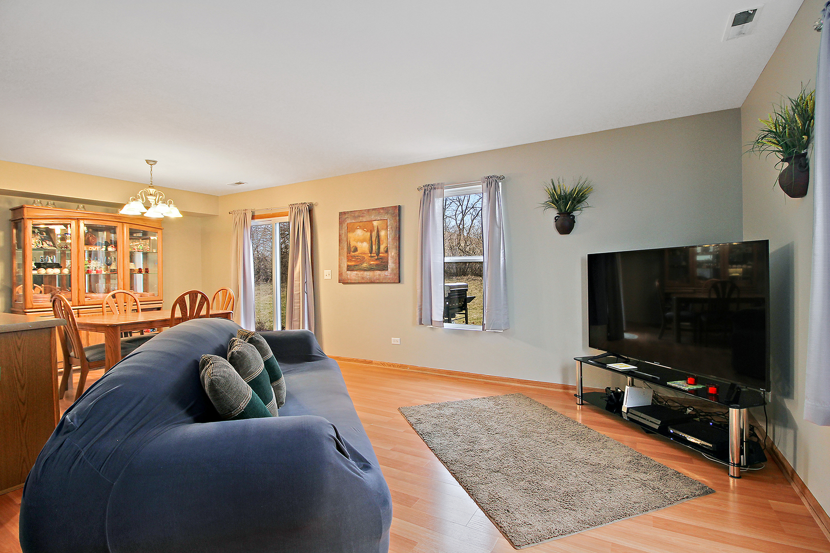25265 Faraday Road, Unit 25265 Manhattan, IL 60442 - Photo 4 of 15 a living room with furniture and a flat screen tv