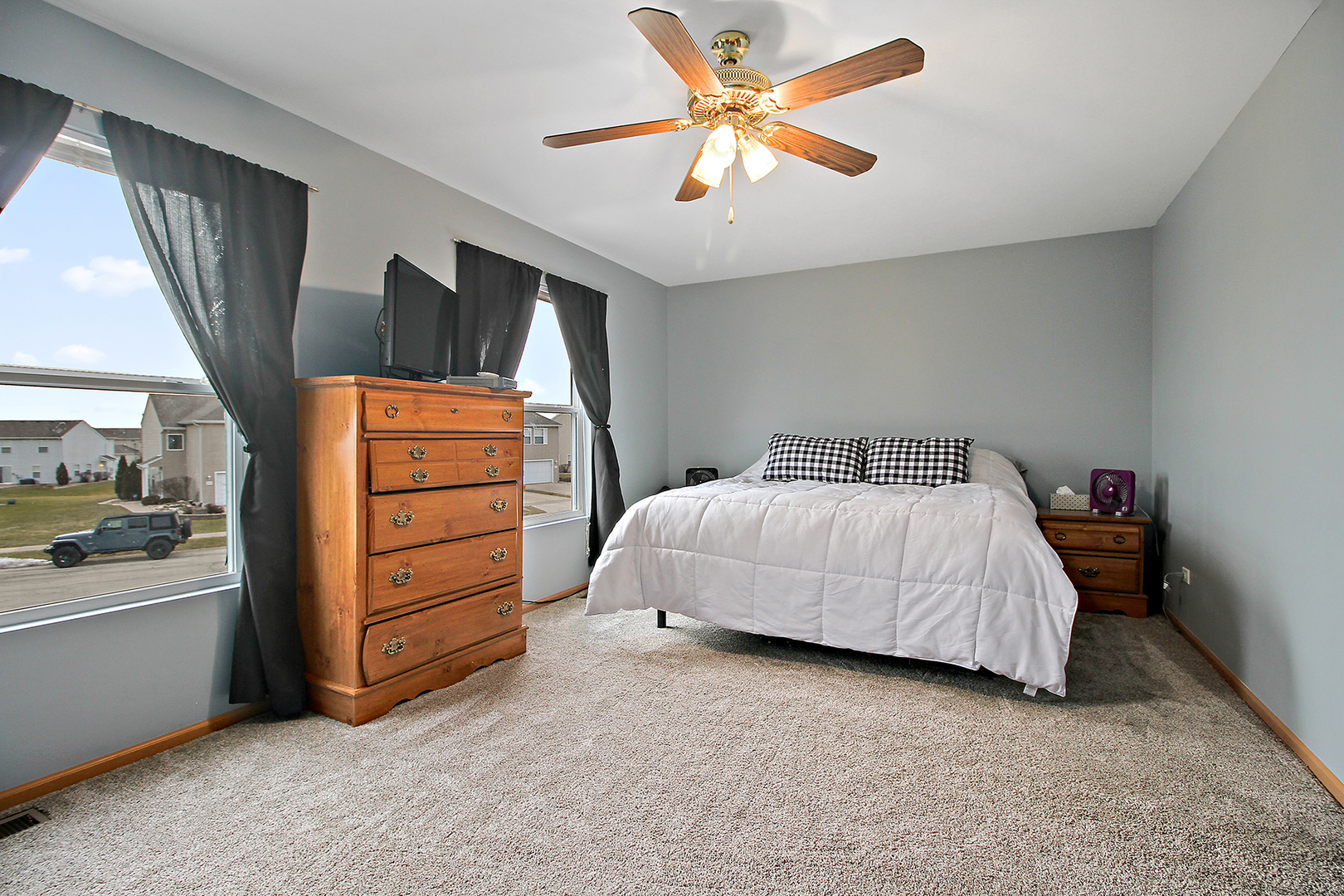 25265 Faraday Road, Unit 25265 Manhattan, IL 60442 - Photo 8 of 15 a bedroom with a bed and a chandelier