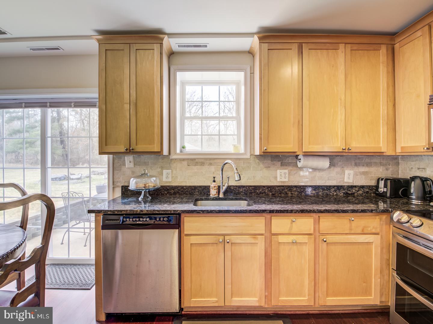 19400 White Ground Road Boyds, MD 20841 - Photo 16 of 59 a kitchen with granite countertop white cabinets and window