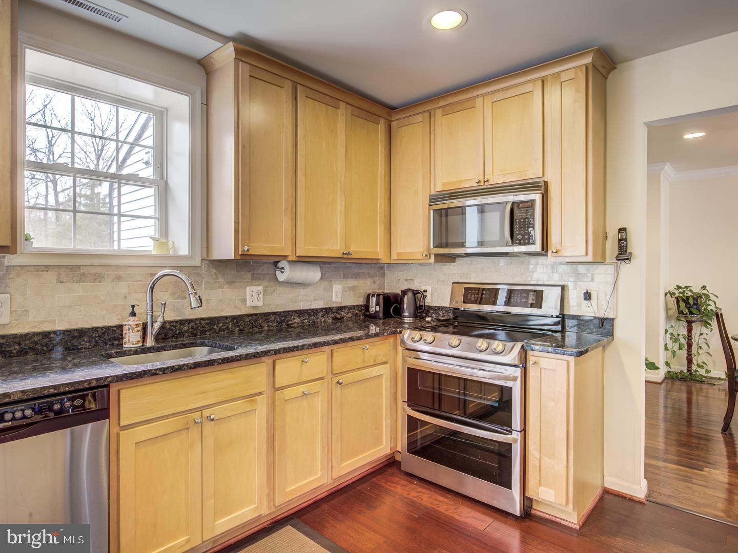 19400 White Ground Road Boyds, MD 20841 - Photo 19 of 59 a kitchen with stainless steel appliances granite countertop a stove and cabinets