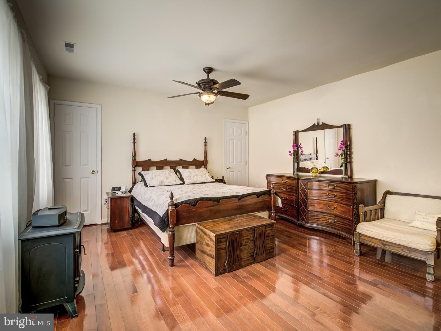 19400 White Ground Road Boyds, MD 20841 - Photo 32 of 59 a bedroom with a bed and a chandelier