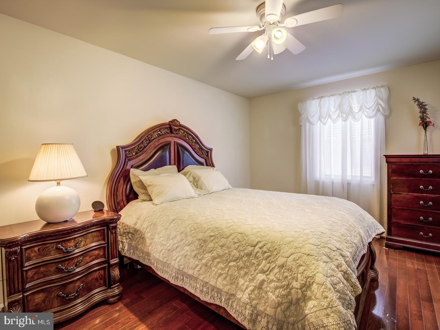 19400 White Ground Road Boyds, MD 20841 - Photo 45 of 59 a bedroom with a bed and lamp with window