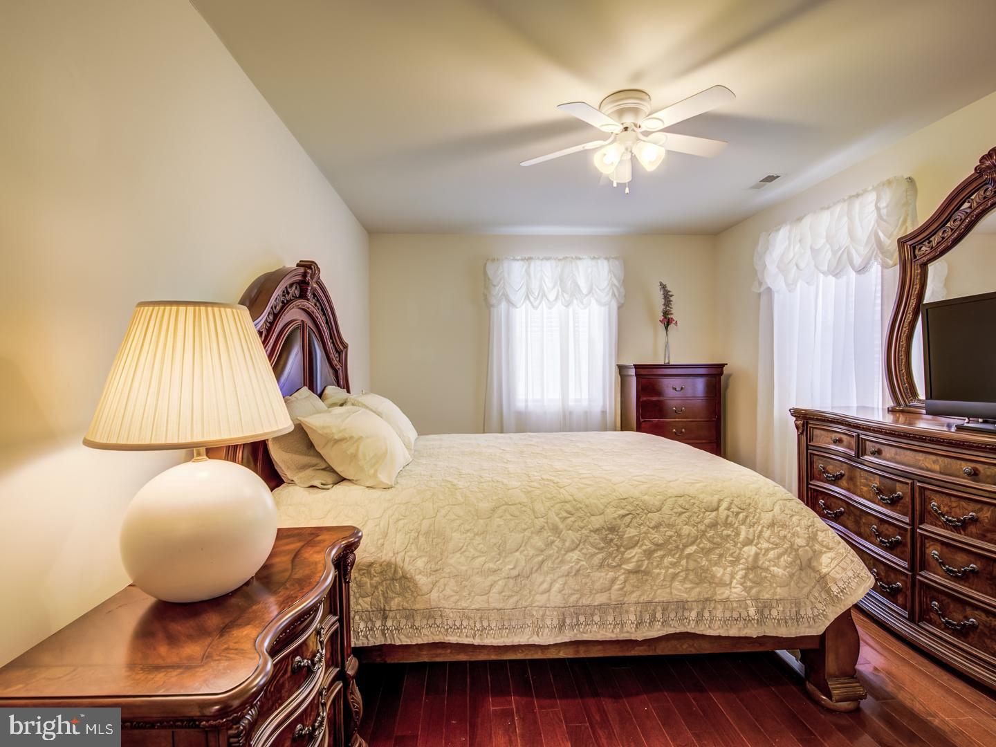 19400 White Ground Road Boyds, MD 20841 - Photo 46 of 59 a bedroom with a bed and wooden floor