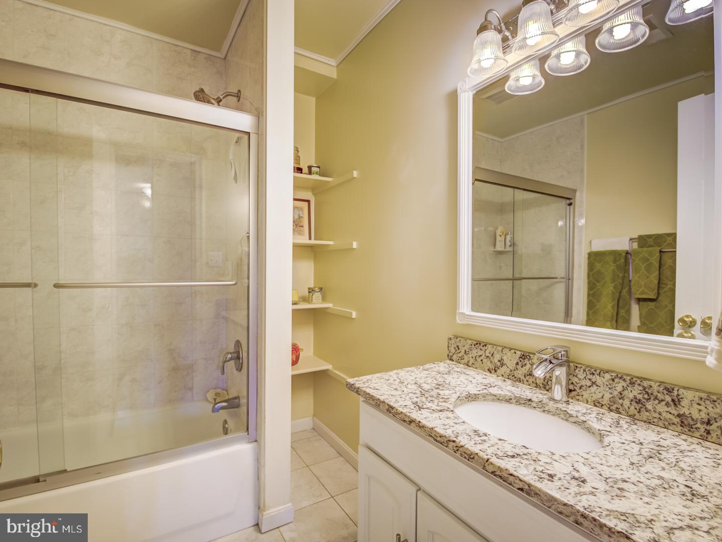 19400 White Ground Road Boyds, MD 20841 - Photo 48 of 59 a bathroom with a granite countertop sink mirror and shower