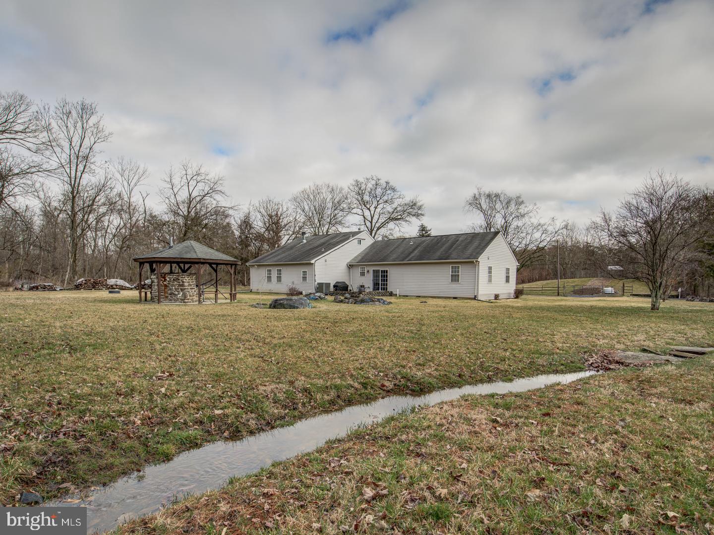 19400 White Ground Road Boyds, MD 20841 - Photo 59 of 59 a view of a large house with a big yard and large trees