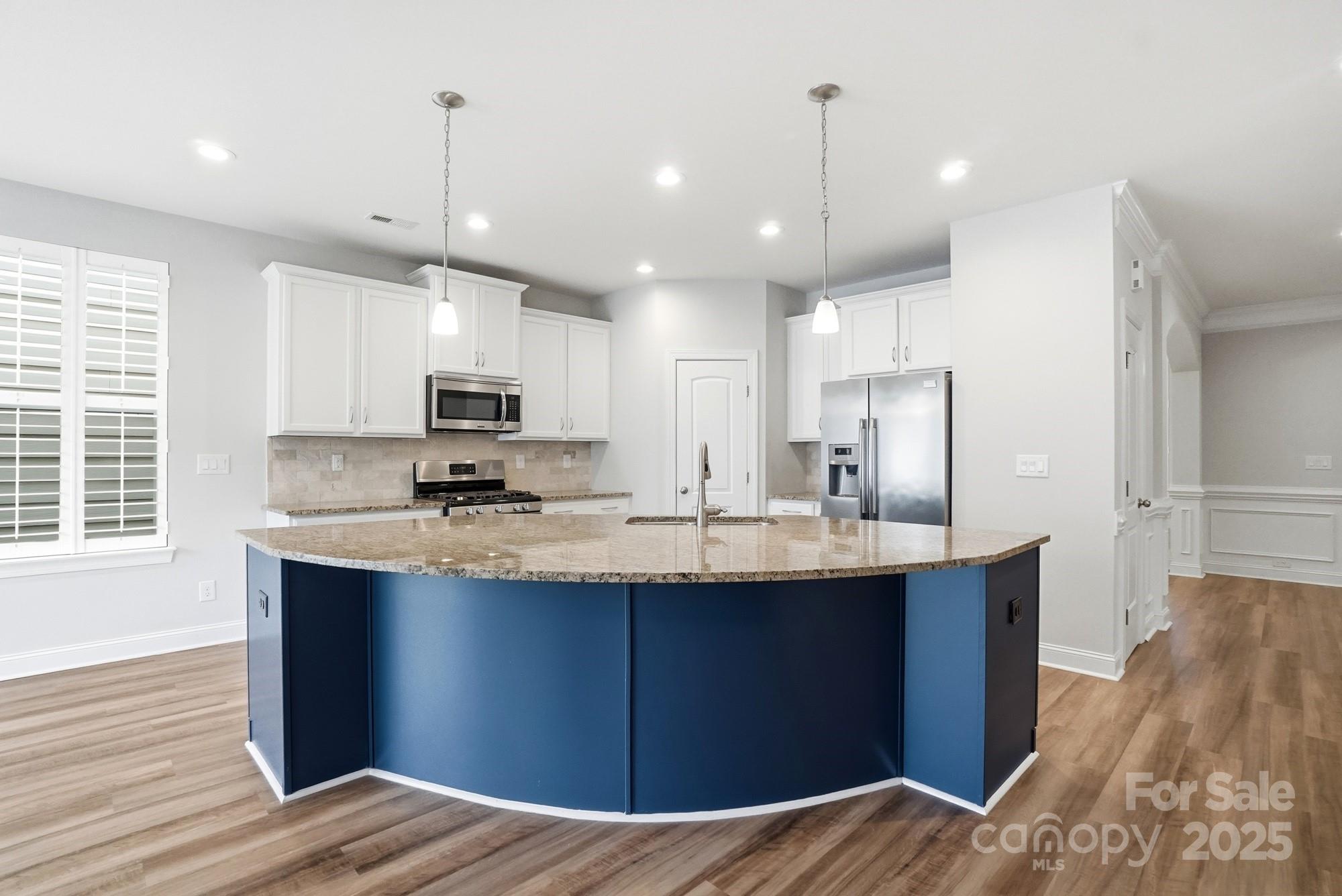 1012 Back Stretch Boulevard Indian Trail, NC 28079 - Photo 13 of 48 a kitchen with kitchen island a sink appliances and cabinets