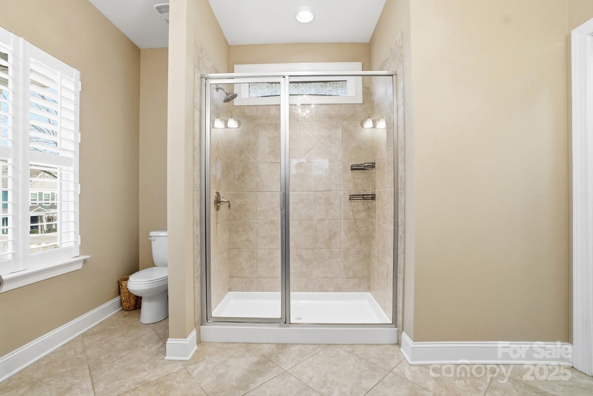 1012 Back Stretch Boulevard Indian Trail, NC 28079 - Photo 25 of 48 a bathroom with a glass shower door