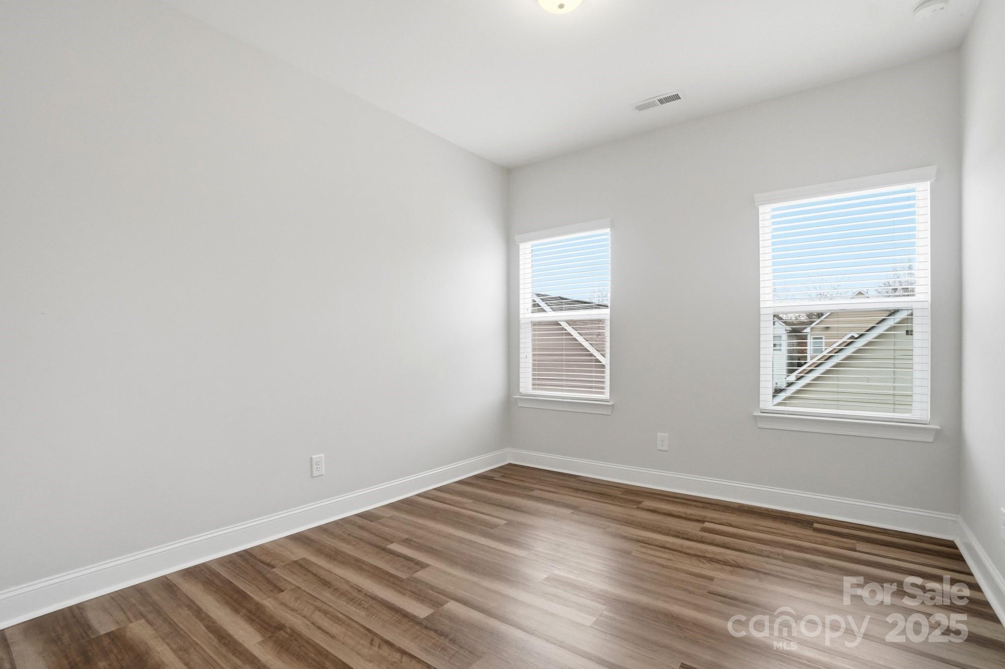 1012 Back Stretch Boulevard Indian Trail, NC 28079 - Photo 29 of 48 an empty room with wooden floor and windows