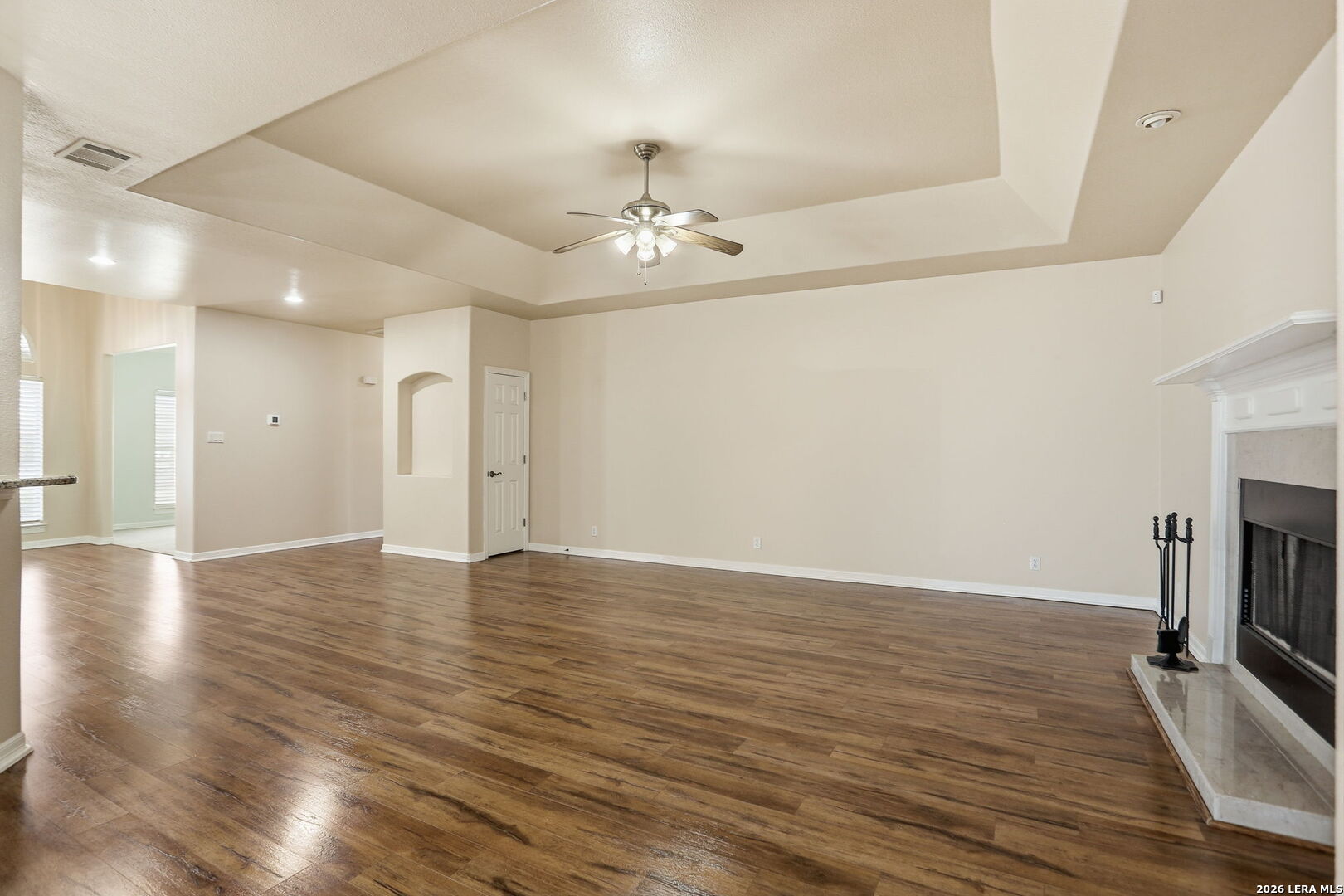 8814 Spanish Moss Windcrest, TX 78239 - Photo 11 of 50 a view of an empty room with a fireplace and wooden floor
