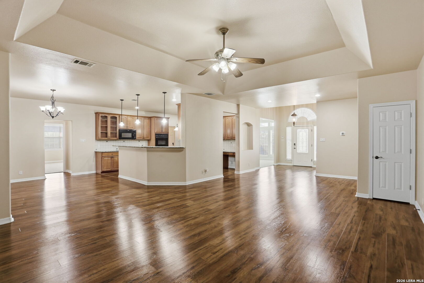 8814 Spanish Moss Windcrest, TX 78239 - Photo 13 of 50 a view of a kitchen with a kitchen island wooden floor and a refrigerator