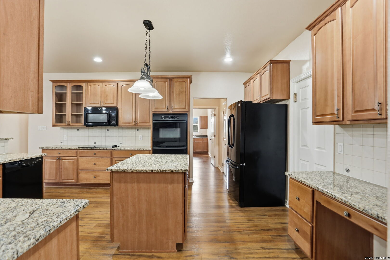 8814 Spanish Moss Windcrest, TX 78239 - Photo 17 of 50 a kitchen with stainless steel appliances granite countertop a refrigerator a sink a stove and oven