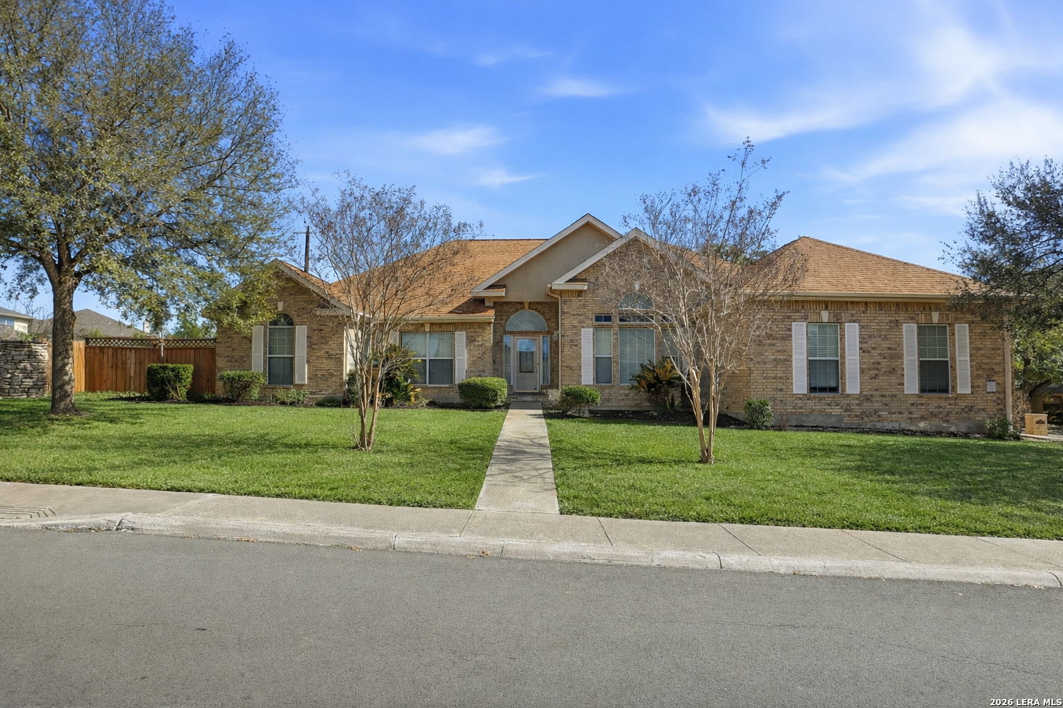 8814 Spanish Moss Windcrest, TX 78239 - Photo 2 of 50 a view of a big house with a big yard and large trees
