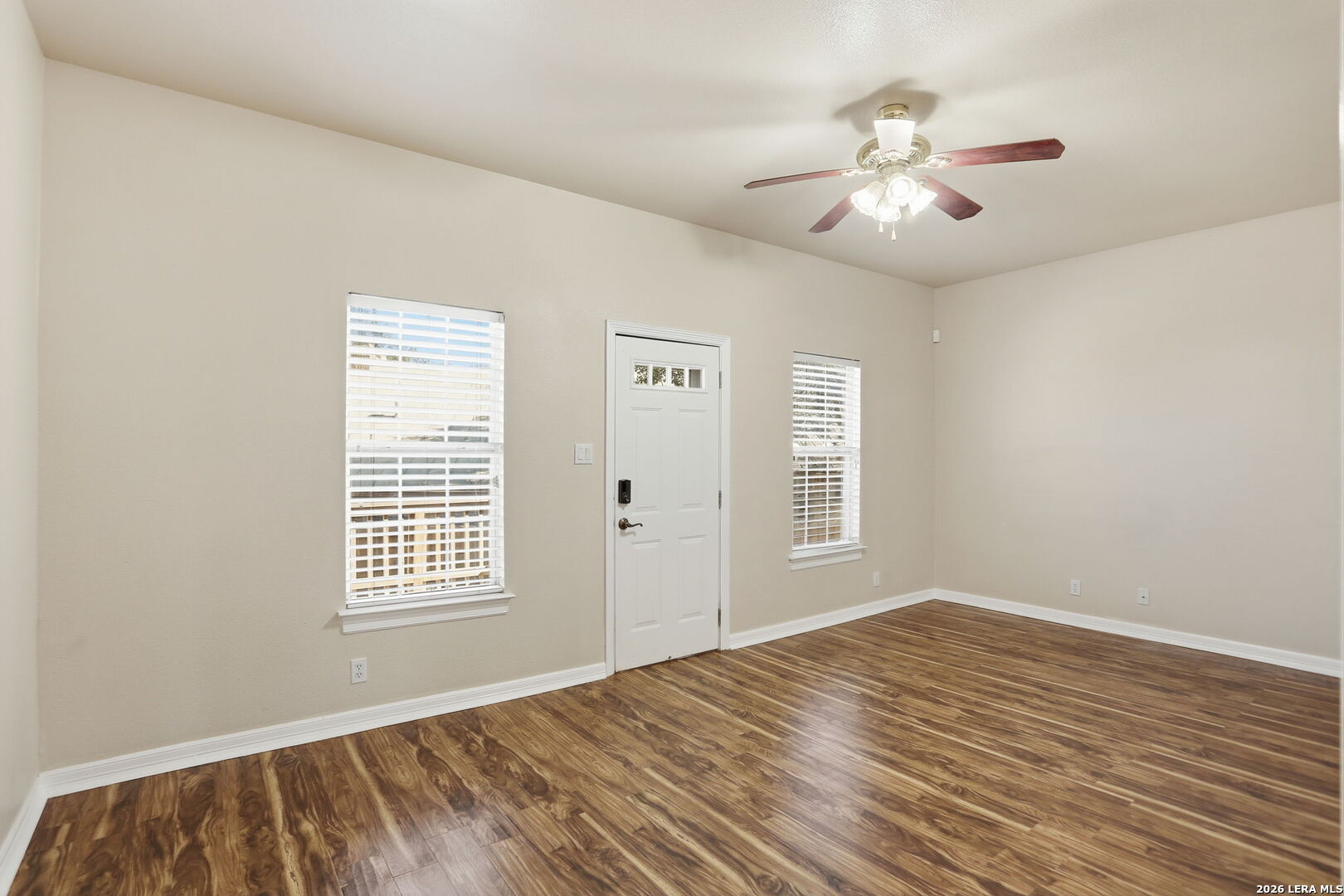 8814 Spanish Moss Windcrest, TX 78239 - Photo 23 of 50 a view of an empty room with wooden floor and a window
