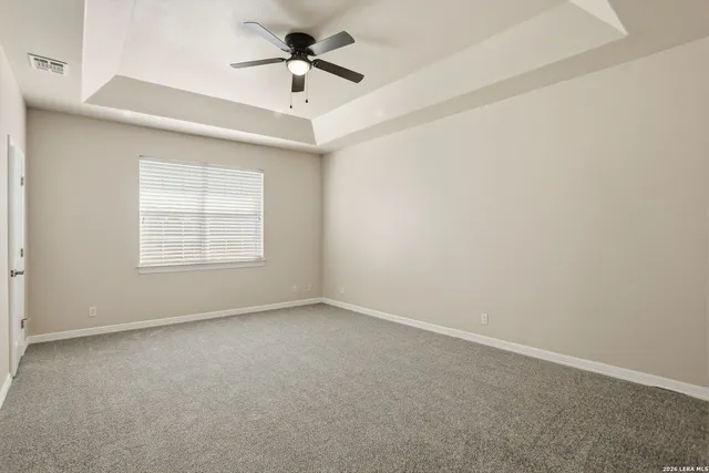 an empty room with a empty space and a ceiling fan