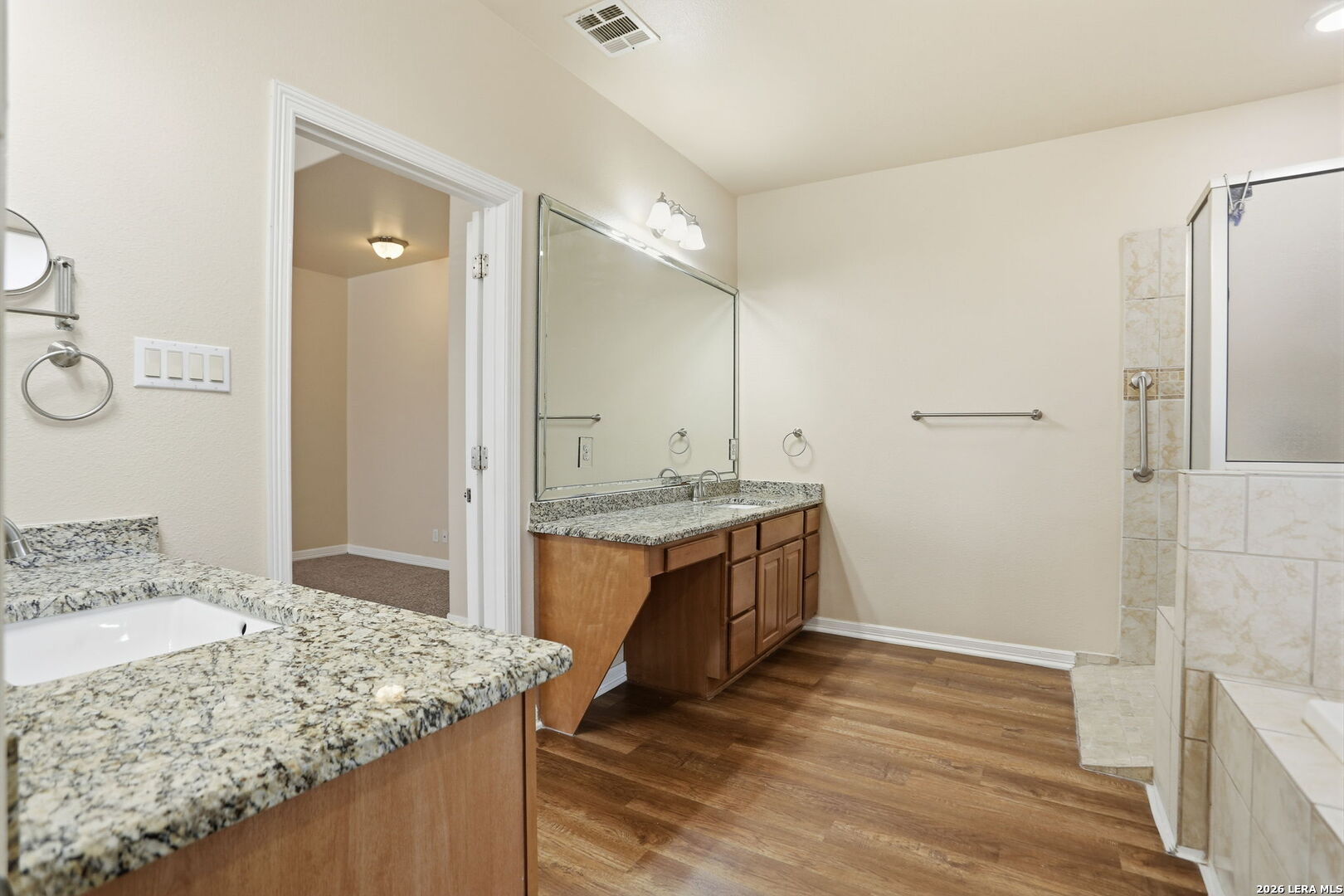 8814 Spanish Moss Windcrest, TX 78239 - Photo 26 of 50 a bathroom with a granite countertop sink and a mirror