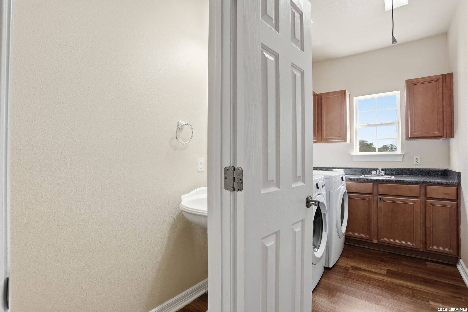 8814 Spanish Moss Windcrest, TX 78239 - Photo 30 of 50 a bathroom with a sink a washer and dryer