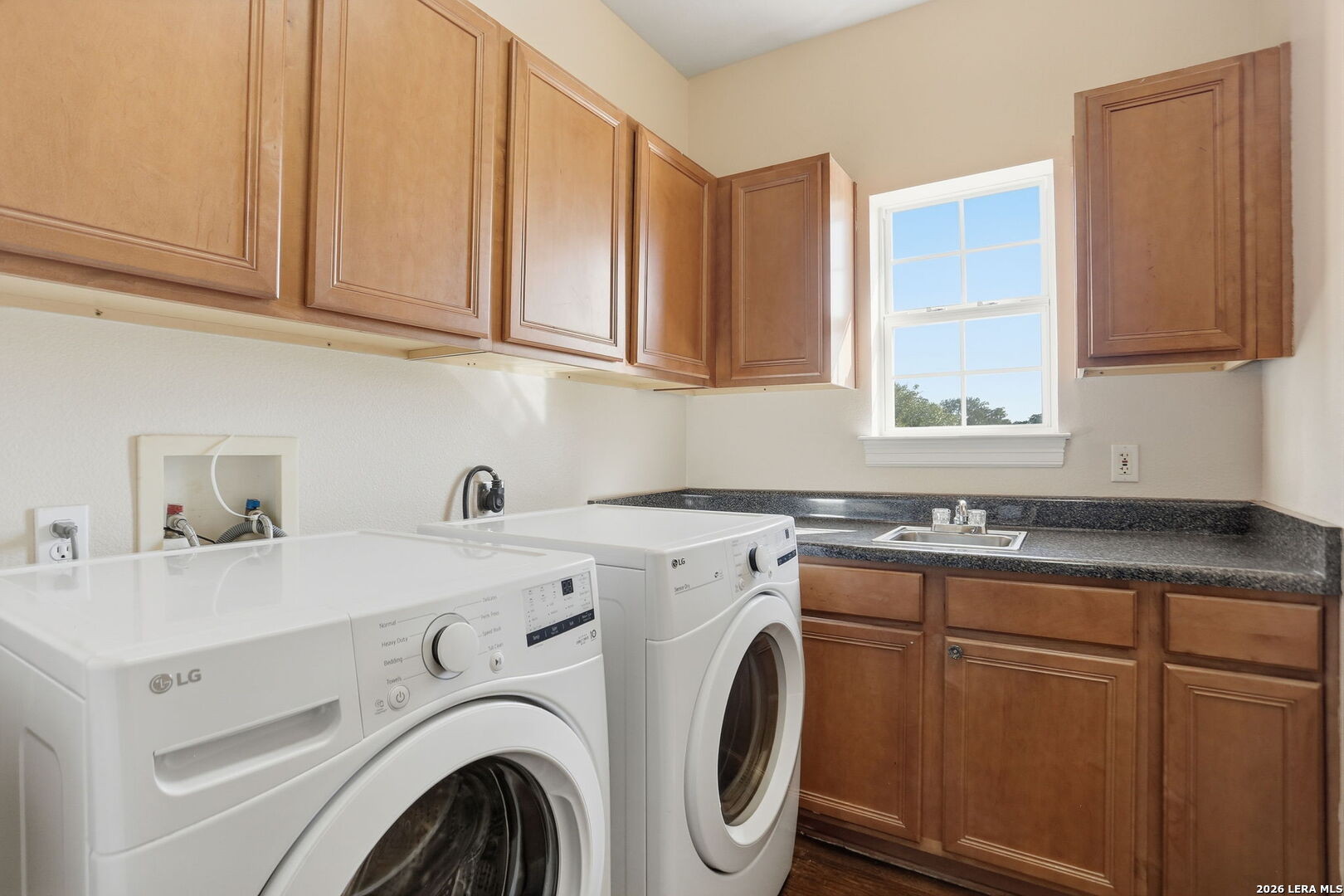 8814 Spanish Moss Windcrest, TX 78239 - Photo 31 of 50 a utility room with sink dryer and washer
