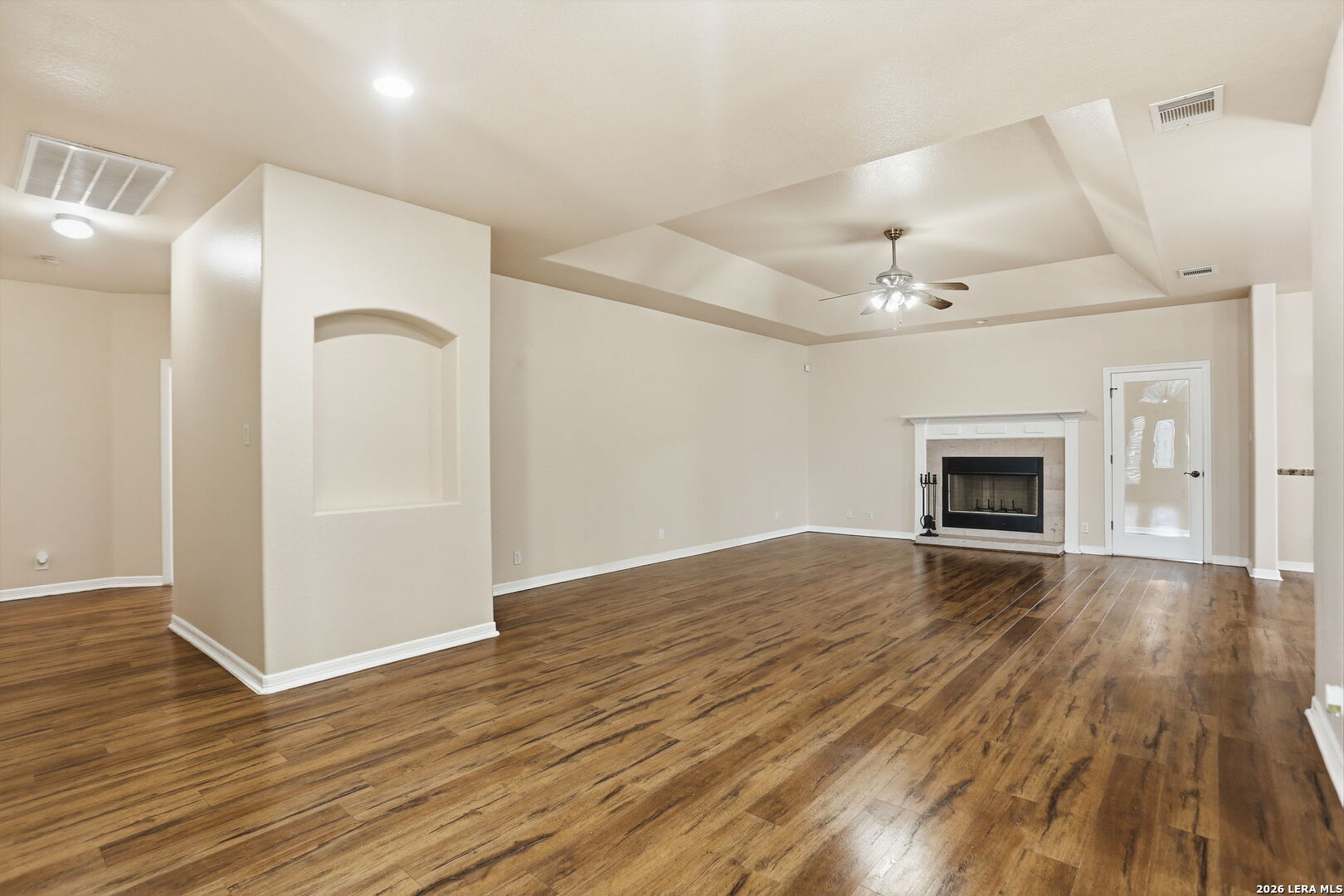 8814 Spanish Moss Windcrest, TX 78239 - Photo 9 of 50 an empty room with wooden floor and fireplace