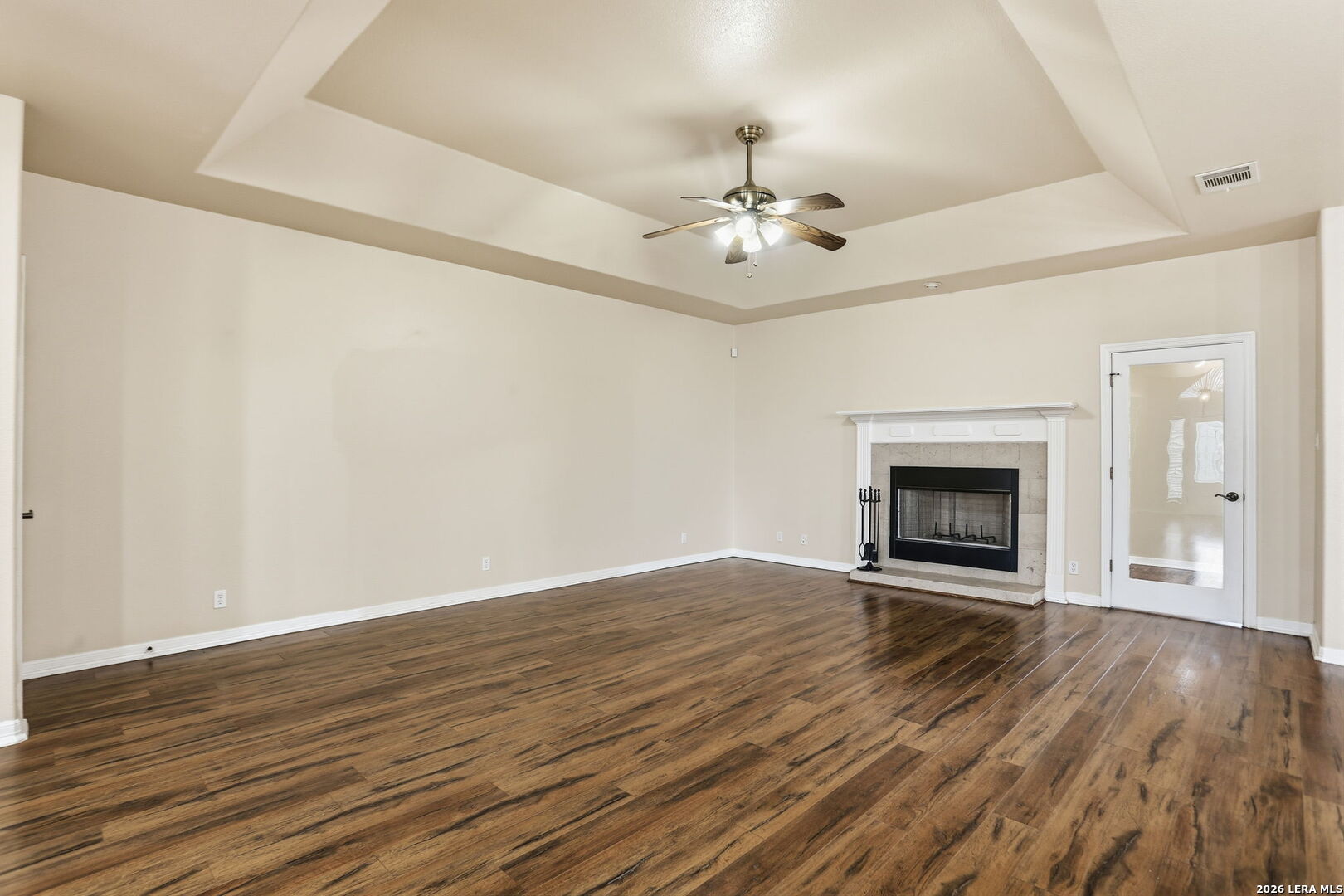 8814 Spanish Moss Windcrest, TX 78239 - Photo 10 of 50 wooden floor in an empty room with a fireplace