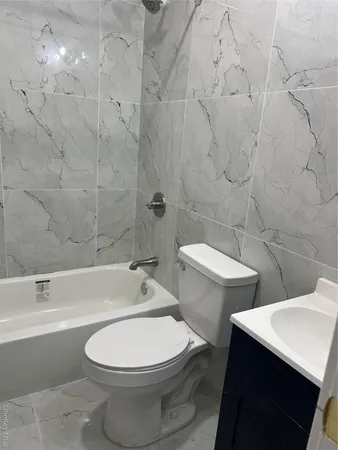 a bathroom with a toilet a sink and bathtub