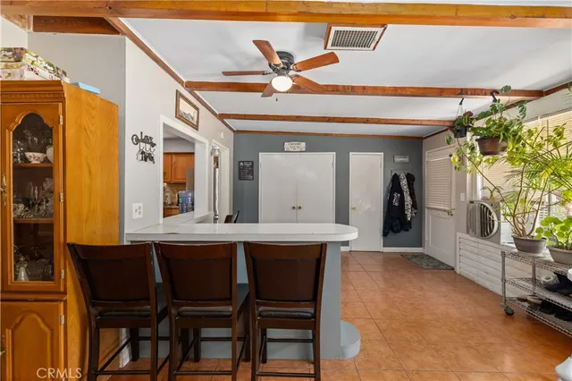 a view of a dining room with furniture and a chandelier