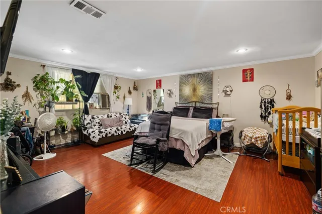 a bed room with furniture and a wooden floor