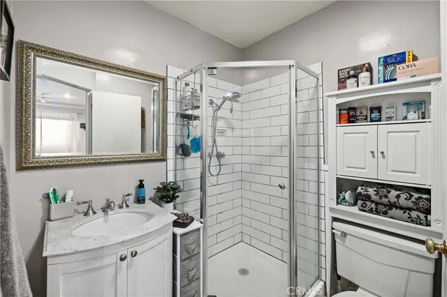 a bathroom with a sink a toilet and shower