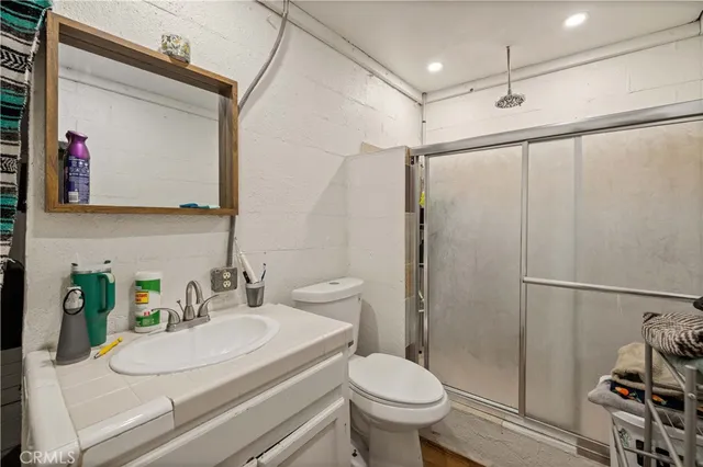 a bathroom with a sink toilet and shower