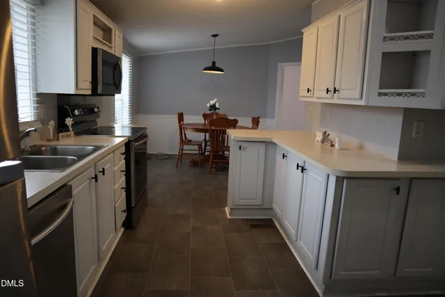 a kitchen with sink cabinets and stove