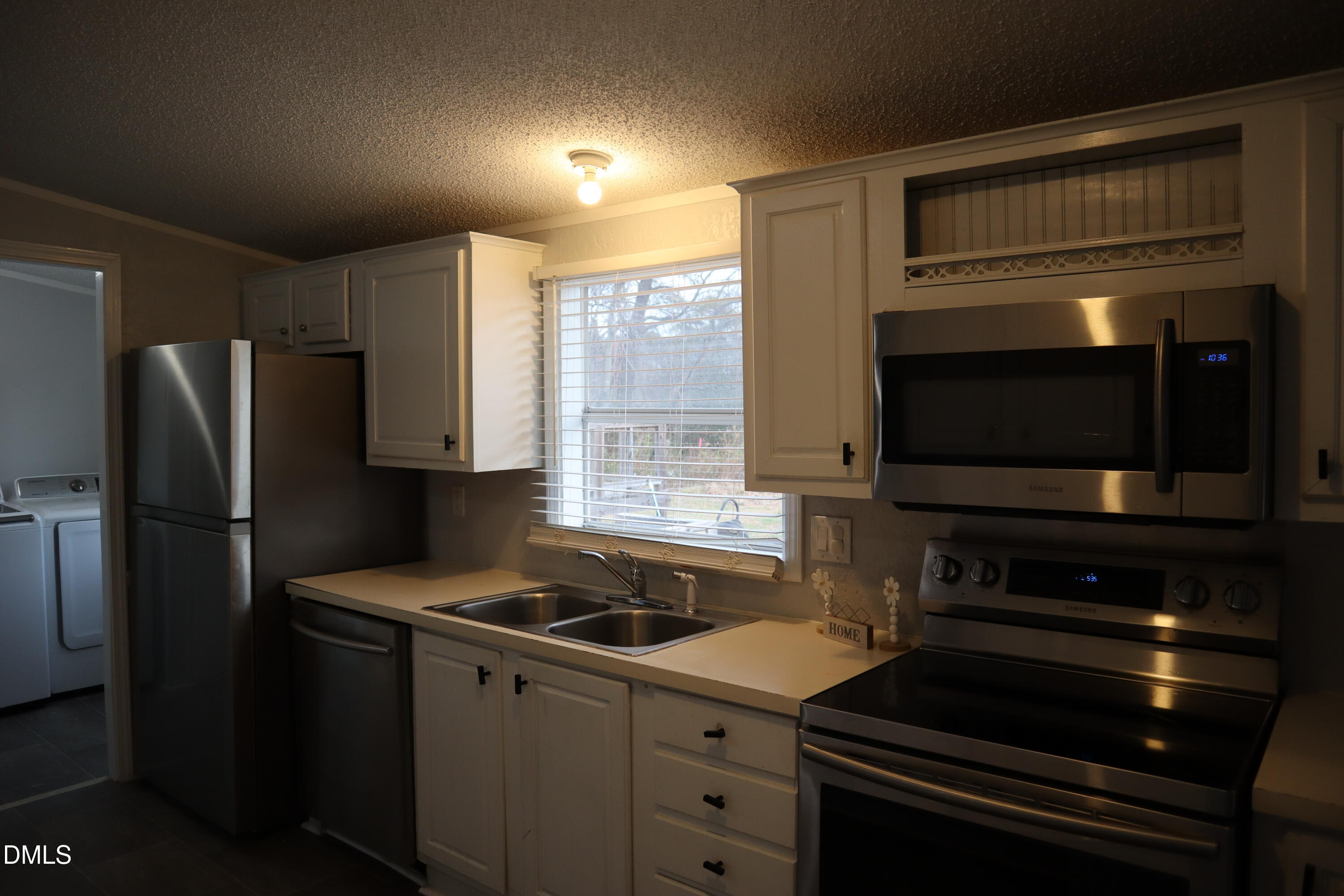 4762 Old Allensville Road Roxboro, NC 27574 - Photo 19 of 33 a kitchen with a refrigerator stove and microwave