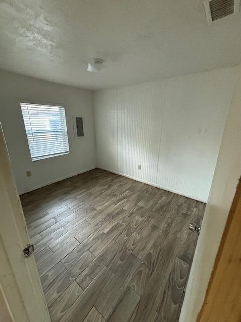 503 North 25th Street, Unit B Fort Pierce, FL 34947 - Photo 5 of 8 an empty room with wooden floor and windows