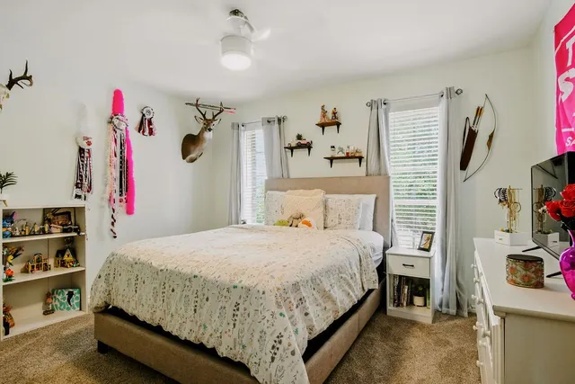 a bedroom with a bed and a window