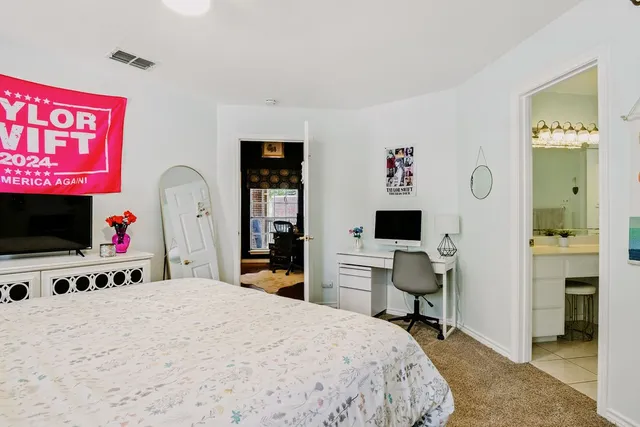 a bedroom with a bed and a flat screen tv