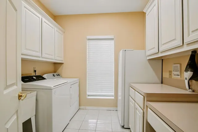 a utility room with a sink washer and dryer