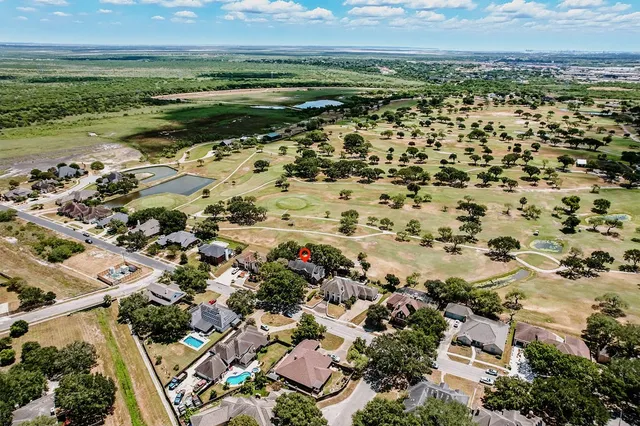 an aerial view of a houses with a lake view