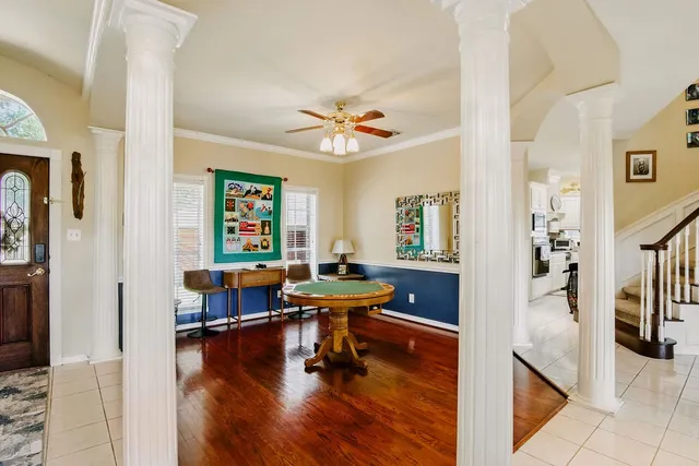 a living room with furniture and wooden floor