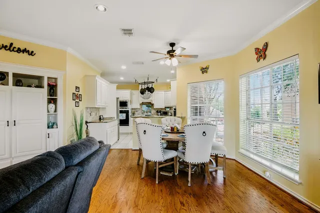 a view of a dining room with furniture window and wooden floor