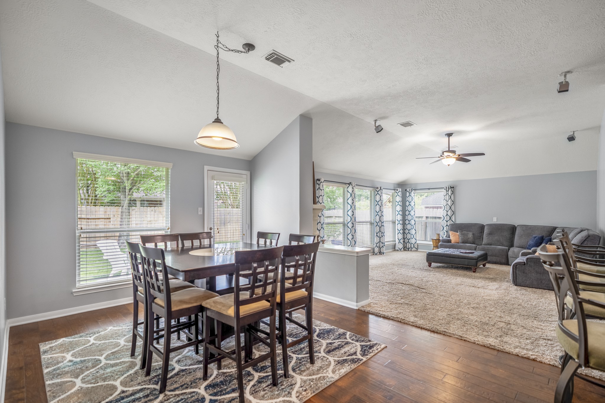 3411 Utah Beach Court Spring, TX 77388 - Photo 14 of 50 Turning toward the family room, the breakfast room becomes the natural connector between the kitchen and the back living area. Natural light comes in through the backyard-facing window and glass door, while the raised bar and island remain close by for an easy flow between cooking, dining, and relaxing.