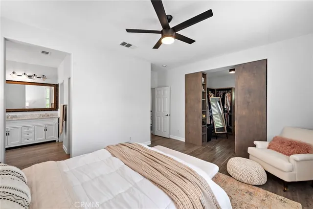 a bedroom with a bed and a tv on the dresser