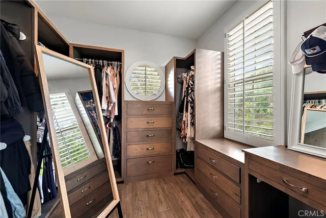 a view of walk in closet with clothes and shoes