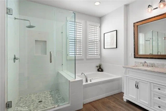 a bathroom with a tub sink and mirror